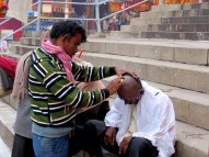 Many pilgrims get their head shaved before bathing in the Ganges.