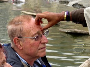 Fellow traveler Stu getting a bindi applied by a Hindu Priest during our boat ride along the Ganges on New Years Day.